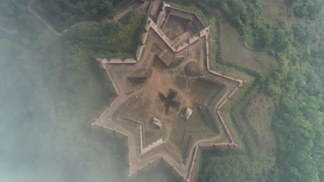 aerial birds eye descending towards star shaped manjarabad fort, india