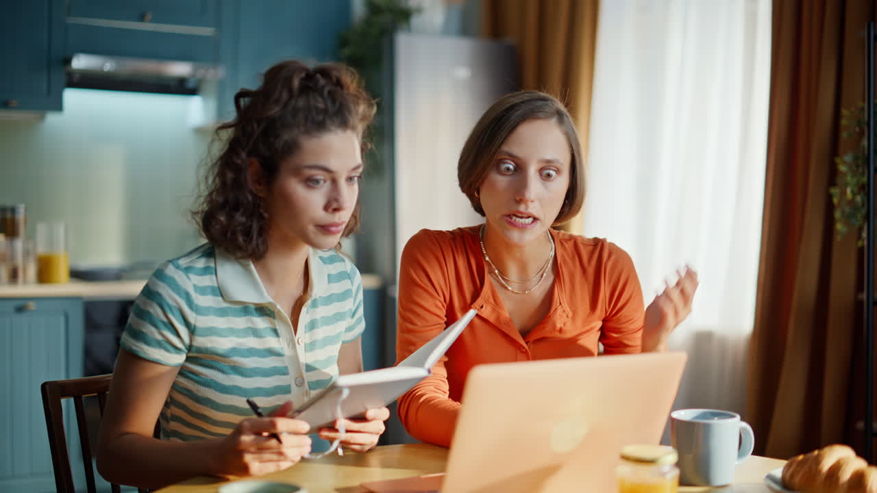 Nervous ladies video calling holding copybook at home closeup. Frustrated women