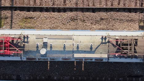 locomotive and tanker wagon transporting gasoline on railroad, aerial top down