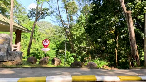 scenic drive with road signs and lush greenery