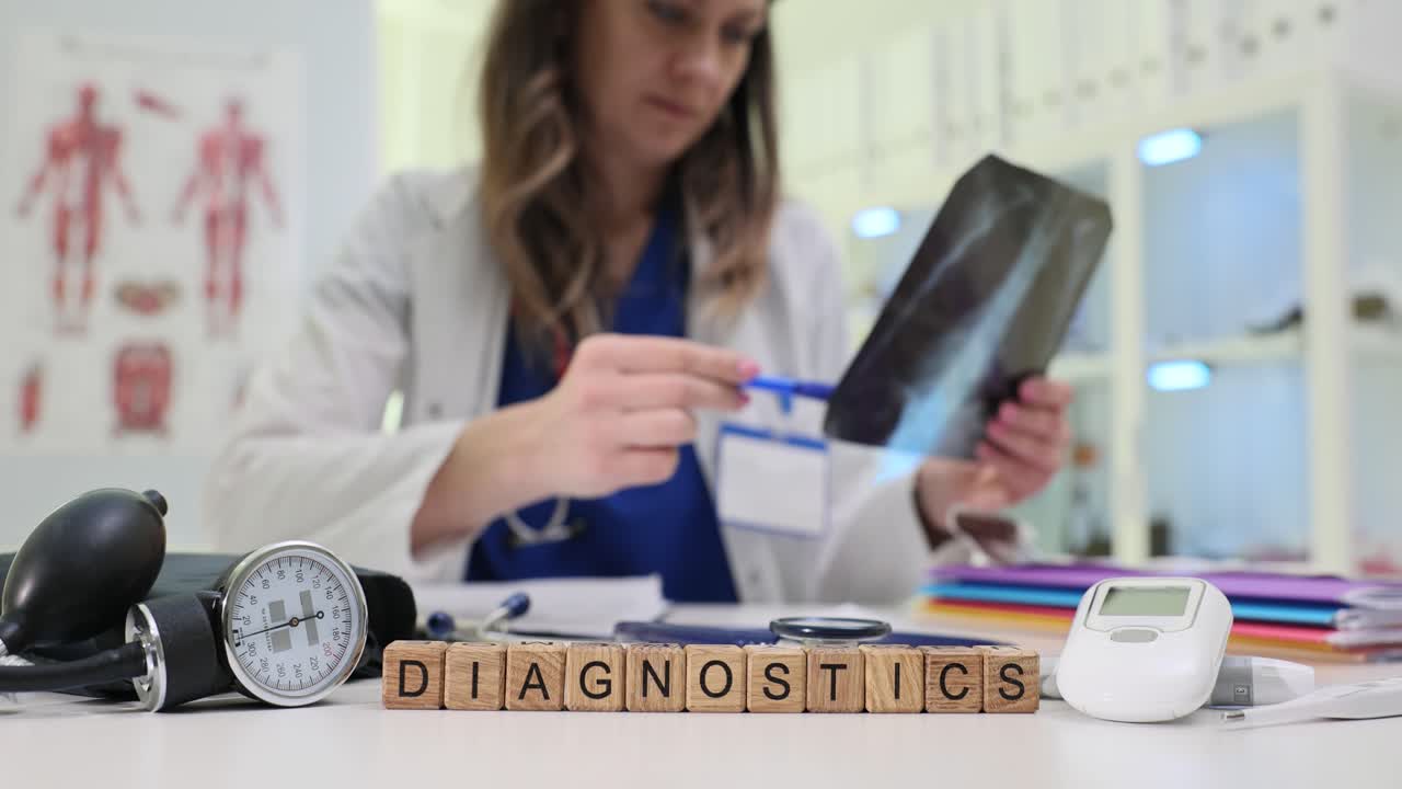 Wooden blocks spell diagnostics near patient xray result image