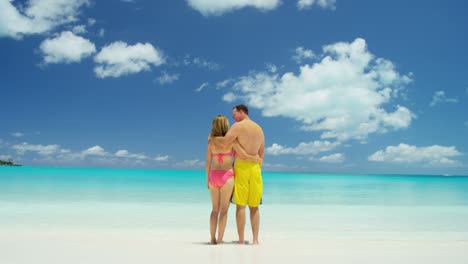 caucasian couple in swimwear at caribbean beach resort