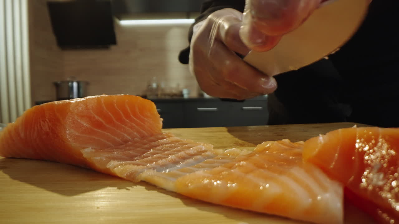 Chef Slicing Fresh Salmon on a Cutting Board