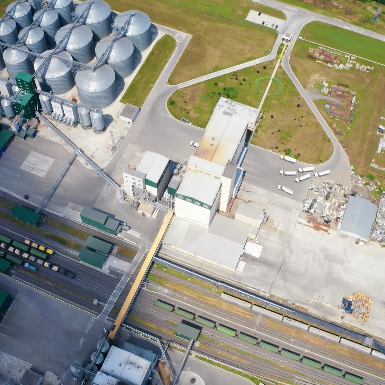 Construction of a new granaries on field. Grain elevators for keeping crop. Building of a modern agricultural complex. Top aerial view