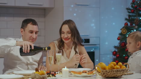 happy large caucasian family of different generations celebrating christmas at home. people having a dinner xmas party eating talking and smiling. high quality 4k footage