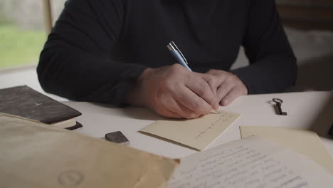 the man takes notes from the letter