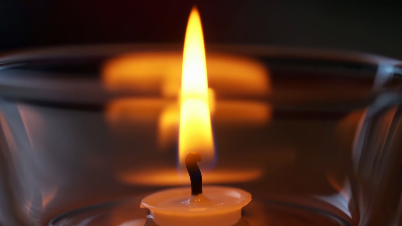 Close Up Candle Flame In Glass, Warm Amber Glow Reflecting On Curved Bowl, Steady Wick With Subtle Flicker,