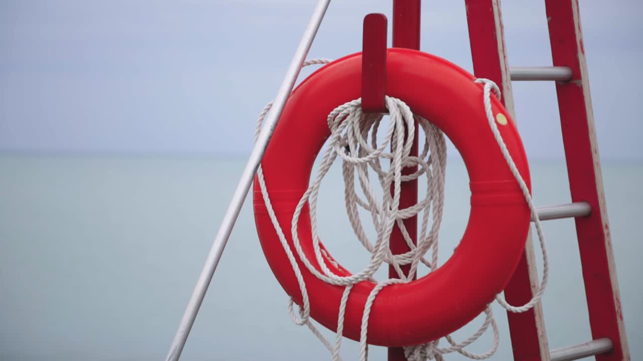 Lifeguard Tower With Orange Buoy And Ladder On The Sandy Beach. -panning up