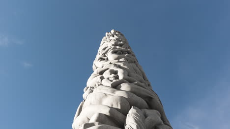 the monolith stone pillar sculpture by gustav vigeland at vigeland facility in frognerparken, oslo, norway