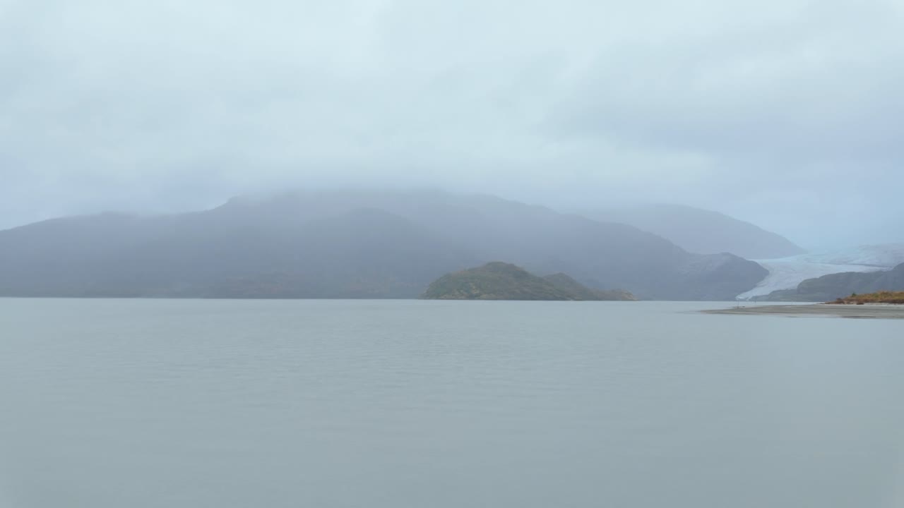 Gimbal wide panning shot of retreating Mendenhall Glacier in Alaska's rainy Tongass National Forest. 4K