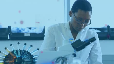 Animation-of-light-spots-over-african-american-female-scientist-in-lab