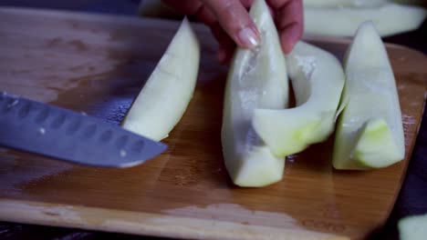 Cutting-pieces-of-papaya-on-cutting-board-Green-and-ripe-yellow-organic-fresh-papaya-pawpaw