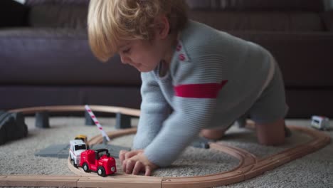 Little-boy-playing-with-toy-track