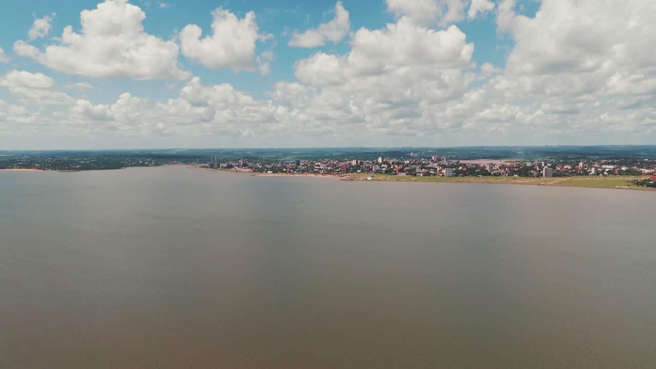 Long shot image of the coastal city Encarnación in Itapúa, Paraguay, highlighting the cityscape and its picturesque waterfront