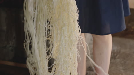 Women-Lifts-Finished-String-Cheese-From-Bucket,-Cheesemaker,-Chobareti,-Georgia