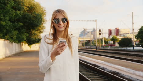 portrait of successful business woman on a trip he talks on the phone at the railway station