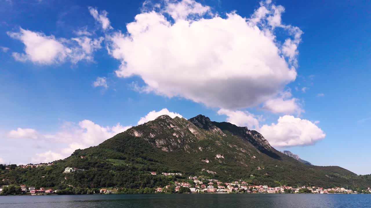 Fly sideways, view of big cloud over mountain at Lake Garlate, Italy