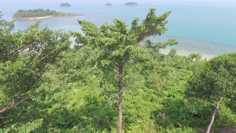 Dense Koh Chang woodland resort aerial view overlooking turquoise ocean tropical islands
