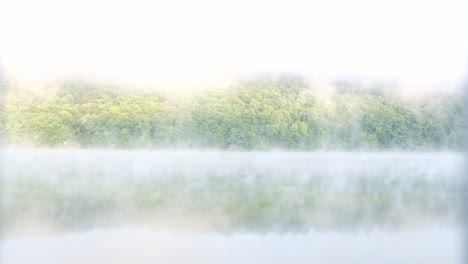 morning fog over a calm lake view from a slow floating pair morning fog over a calm lake view from a slow floating pair fog over the lake at dawn before sunrise