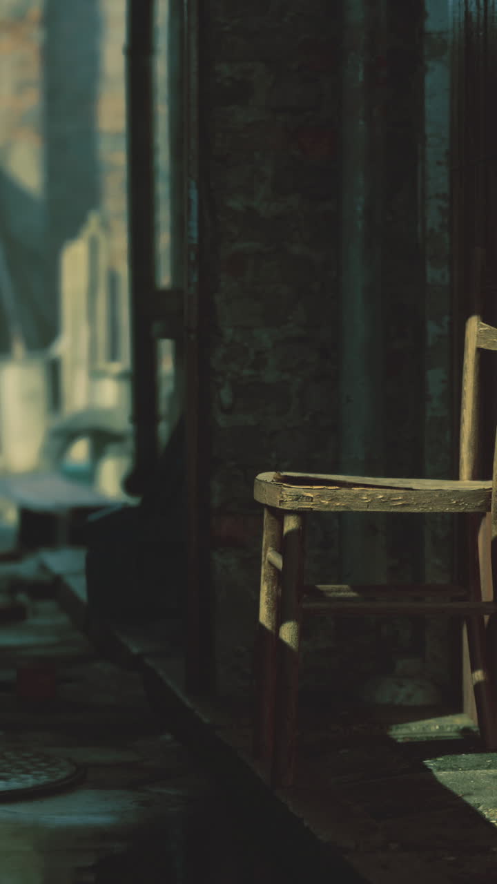 Abandoned alley with wooden chair and weathered walls at dusk