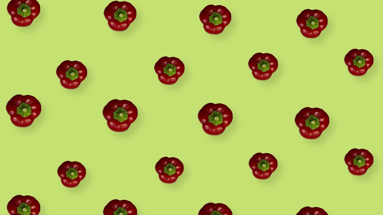 patrón colorido de pimentón fresco sobre fondo amarillo. patrón sin costuras con pimentón. vista superior. animación realista. movimiento de video 4k