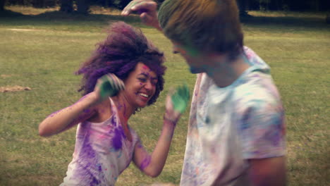 in high quality format happy friends throwing powder paint