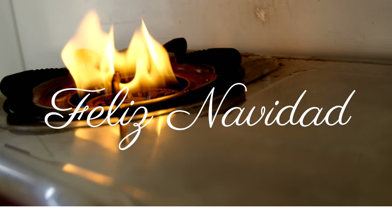 Feliz Navidad text animation over close-up of lit gas stove burner