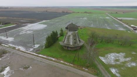 beautiful aerial establishing view of old wooden windmill in the middle of the field, prenclavu windmill , overcast winter day, wide drone shot moving backward, tilt up