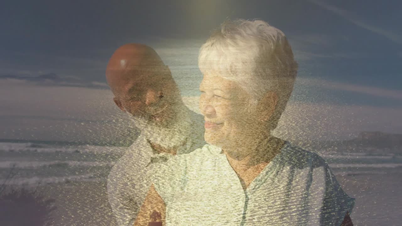 Retired couple standing at beach, overlay building and revealing man behind woman, reminiscing