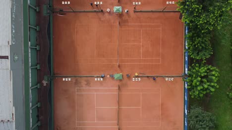 bird`s eye shot of 3 clay tennis courts