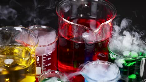 beakers with colorful liquids and dry ice reaction