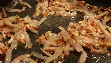 melting the bacon in a pan to make italian pasta, close up shot