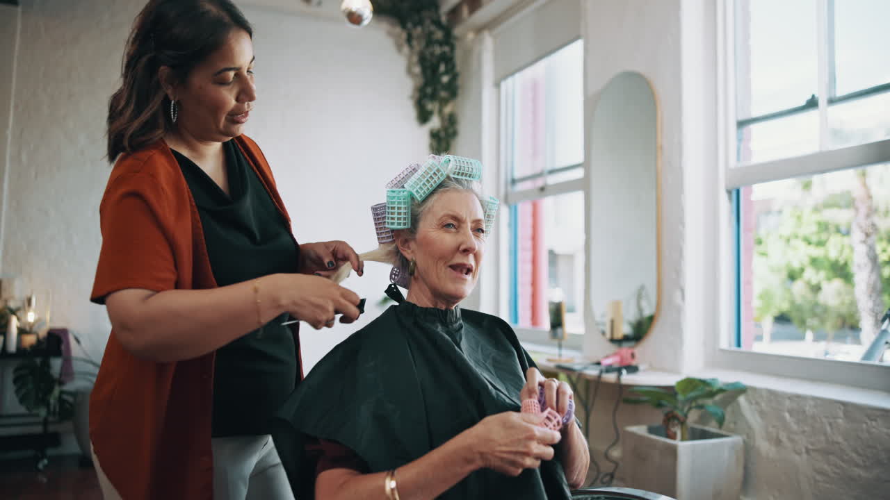 Hairstylist Applying Rollers to Senior Woman's Hair in Salon