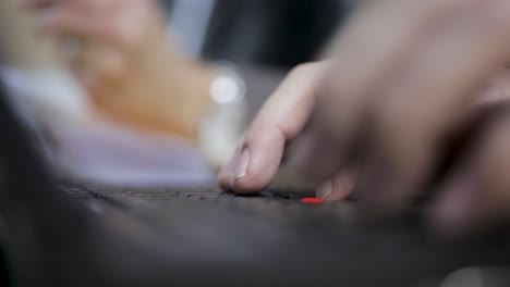 close-up of hands typing rapidly on a laptop keyboard, focus on fingers and keys