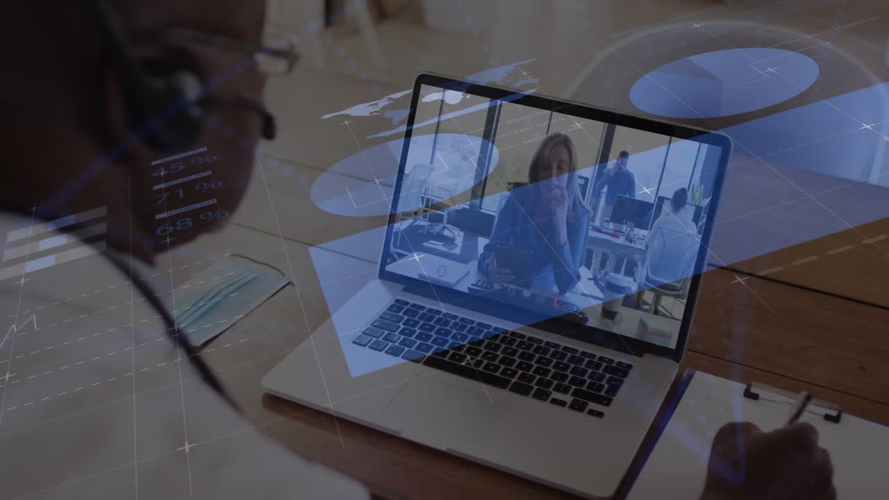 Animation of data processing against african american man having video call on laptop at office