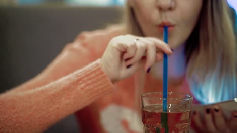 Young-beautiful-girl-is-sitting-in-a-cafe-2