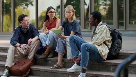 students discussing on campus stairs