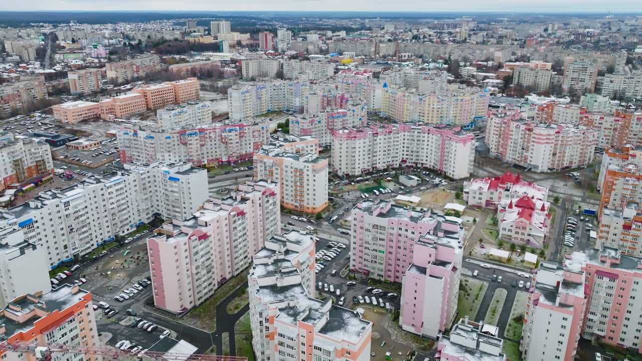 High-rise apartment buildings in a modern residential urban area. Drone flight over the beautiful city district against the cityscape.