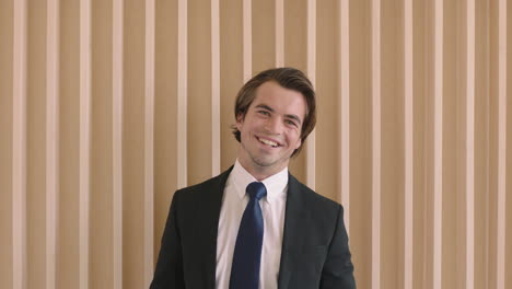 close up portrait of handsome young successful businessman smiling happy wearing stylish suit positive male entrepreneur