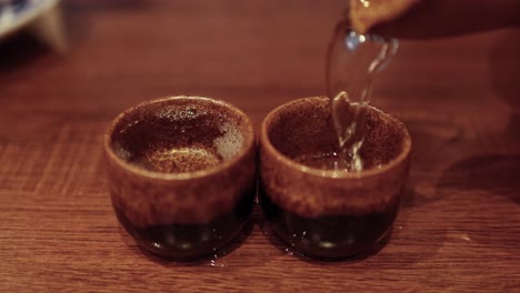 tea being poured into two cups