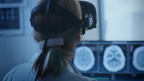 futuristic concept: in medical control room female doctor wearing virtual reality headset monitors patient undergoing mri or ct scan procedure. computer displays shows brain scans.