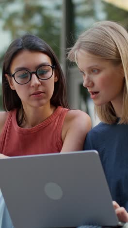 two women collaborating on a laptop