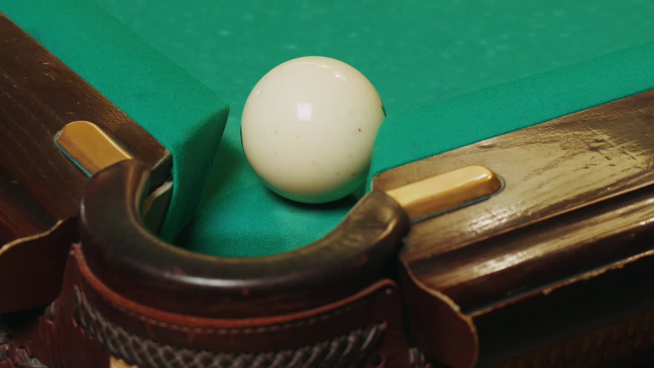 Playing billiard game. White pool balls close-up on green billiards table for start to play. Russian game, Russian pyramid. Billiard balls with numbers on a pool table. Billiards team sport.High quality 4k footage