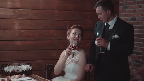 Young-man-and-his-beautiful-girl-hit-glasses-then-they-drink-wine-during-dinner-in-a-restaurant-slow-motion