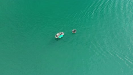 drone view fishermen is dragging a basket boat on my khe beach - da nang city, vietnam