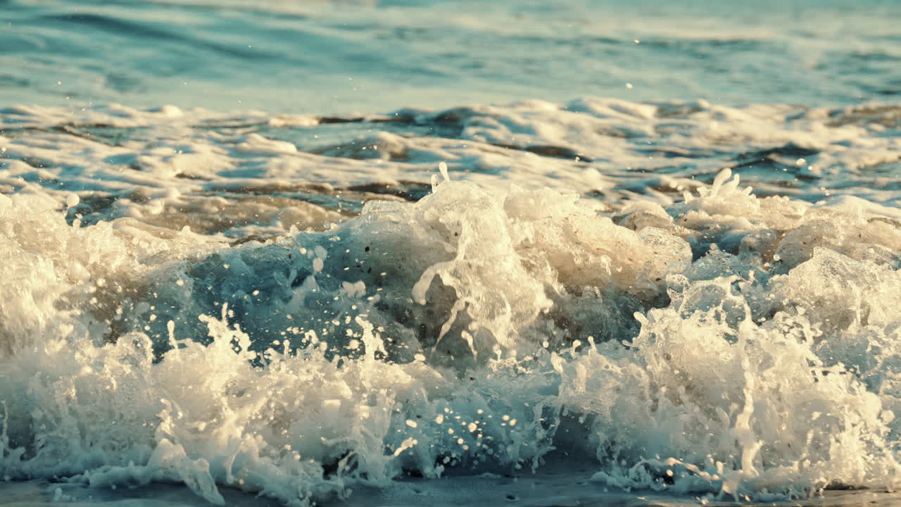 Ocean waves breaking and foaming as they approach the shoreline