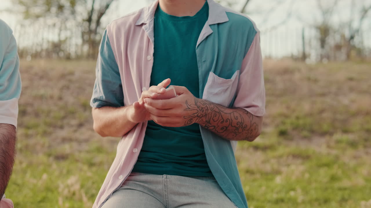 Friends Playing Cards at a Picnic