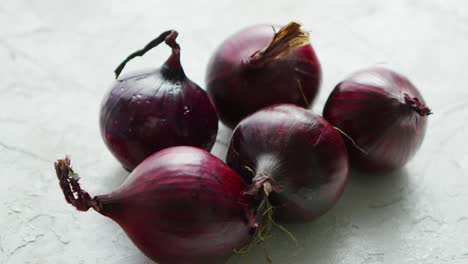 red onion bulbs on white table