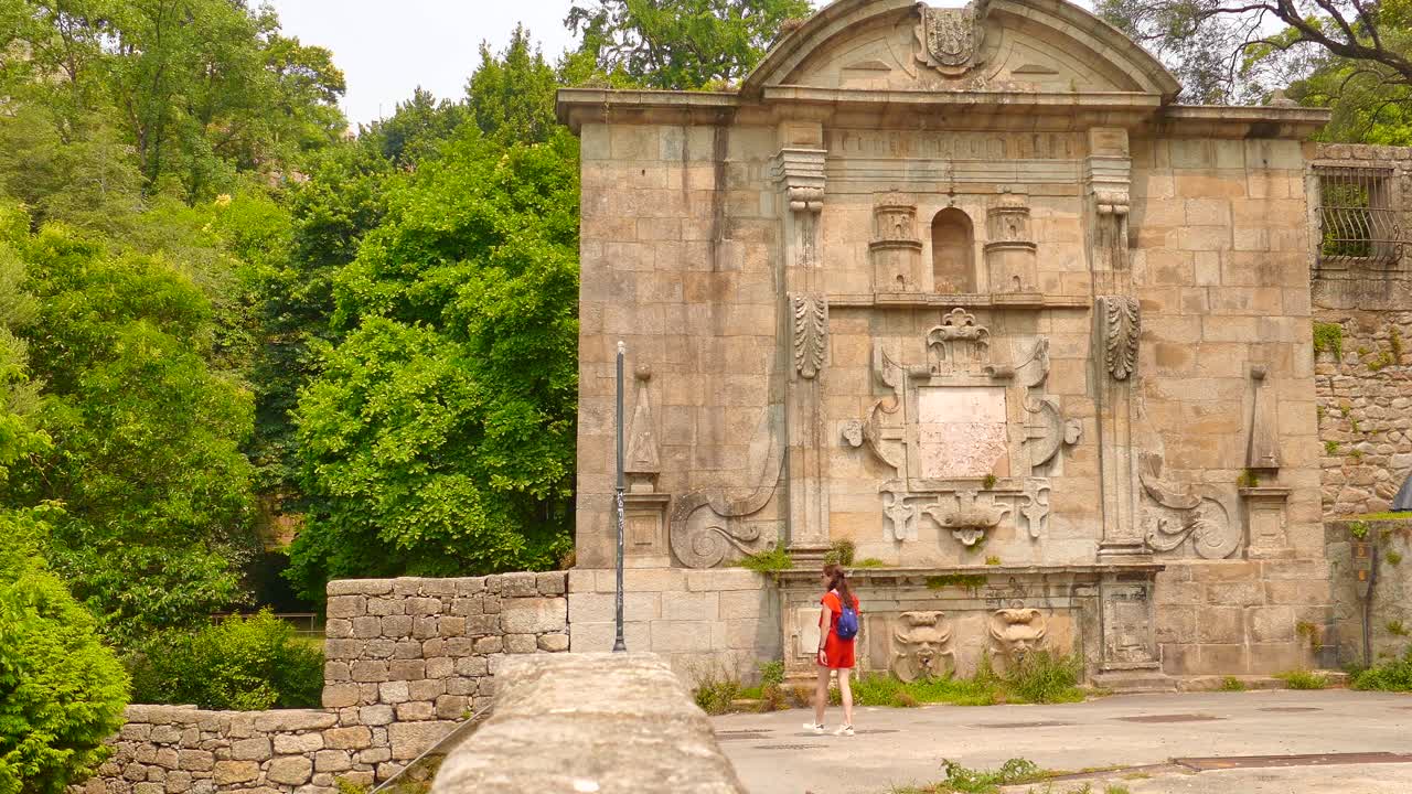 Virtudes Garden in Porto, Portugal, a girl wearing a red dress walking next to the tourist attraction