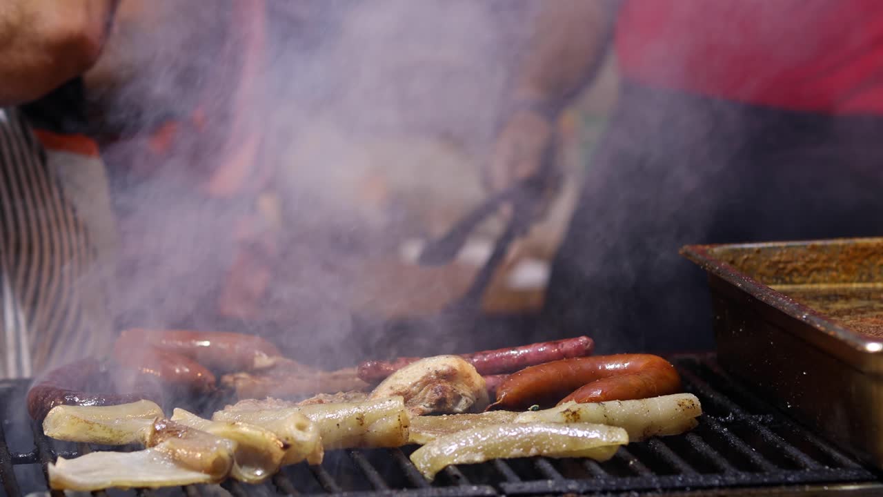 Street Food. Pork meat and sausages being cooked over hot charcoal fire